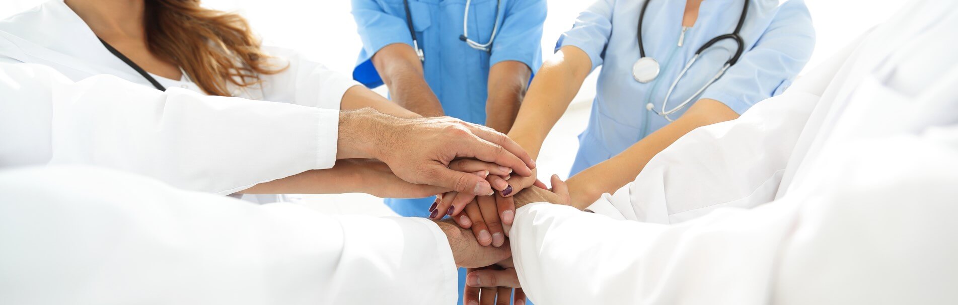 Doctors Putting Their Hands In In A Huddle